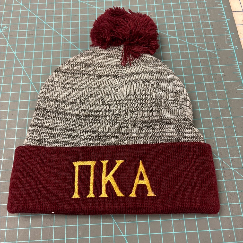 Knit toboggan embroidered with Greek letters Pi Kappa Alpha.